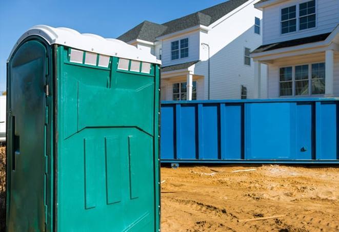 a row of portable toilets at a busy work site